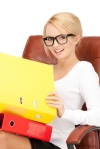 young businesswoman with folders sitting in chair